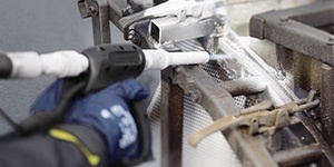 Kärcher Trockeneisstrahl-Technologie Detailansicht einer Kärcher Strahldüse bei der präzisen Reinigung eines Metallrahmens.