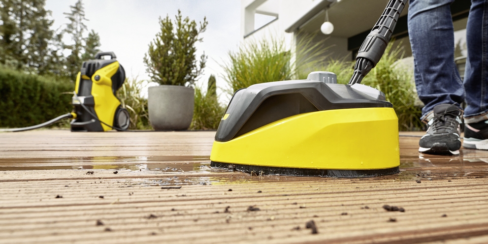 Een houten terras reinigen Kärcher: een man reinigt een houten terras