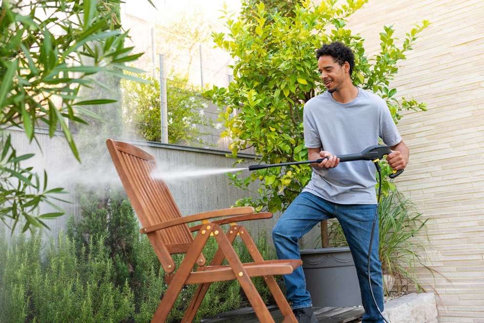 Person reinigt Gartenstuhl mit Hochdruckreiniger Hochdruckreiniger-Zubehöre