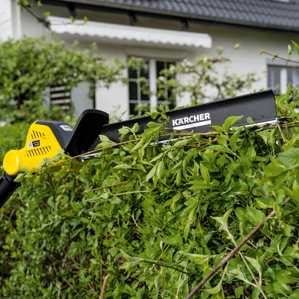 Schnittgutkehrer die Kärcher Akku-Heckenschere mit Schnittgutkehrer im Einsatz an einer Hecke