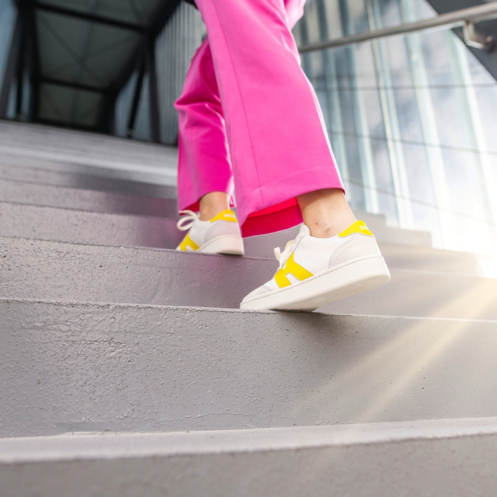 Person walking up the stairs in a Kärcher building