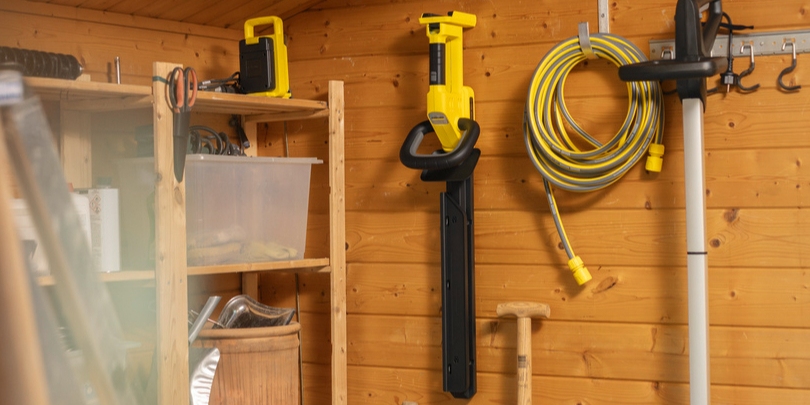Kärcher battery hedge trimmer stored in a shed