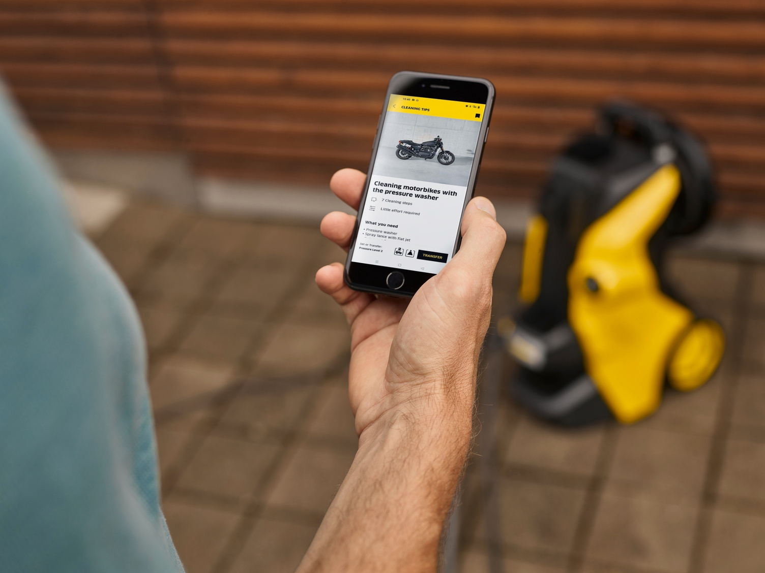 Person holding aphone using the Home & Garden App