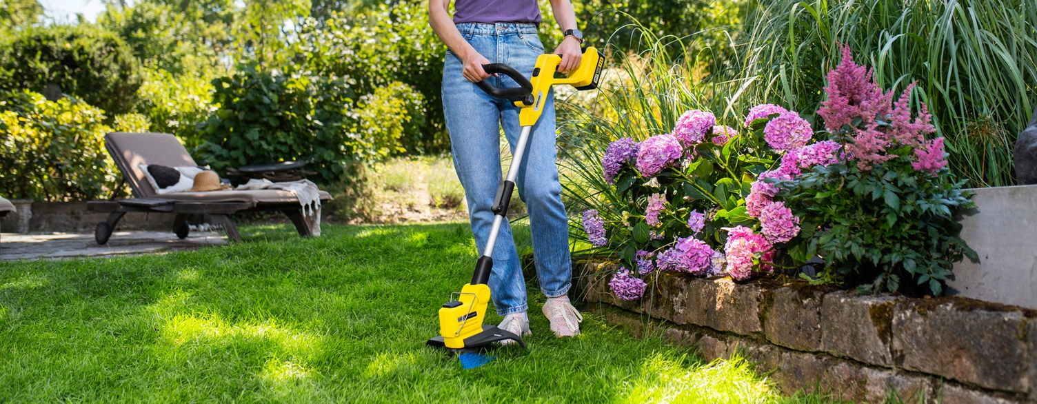 Person trimming their lawn with the Kärcher battery lawn trimmer