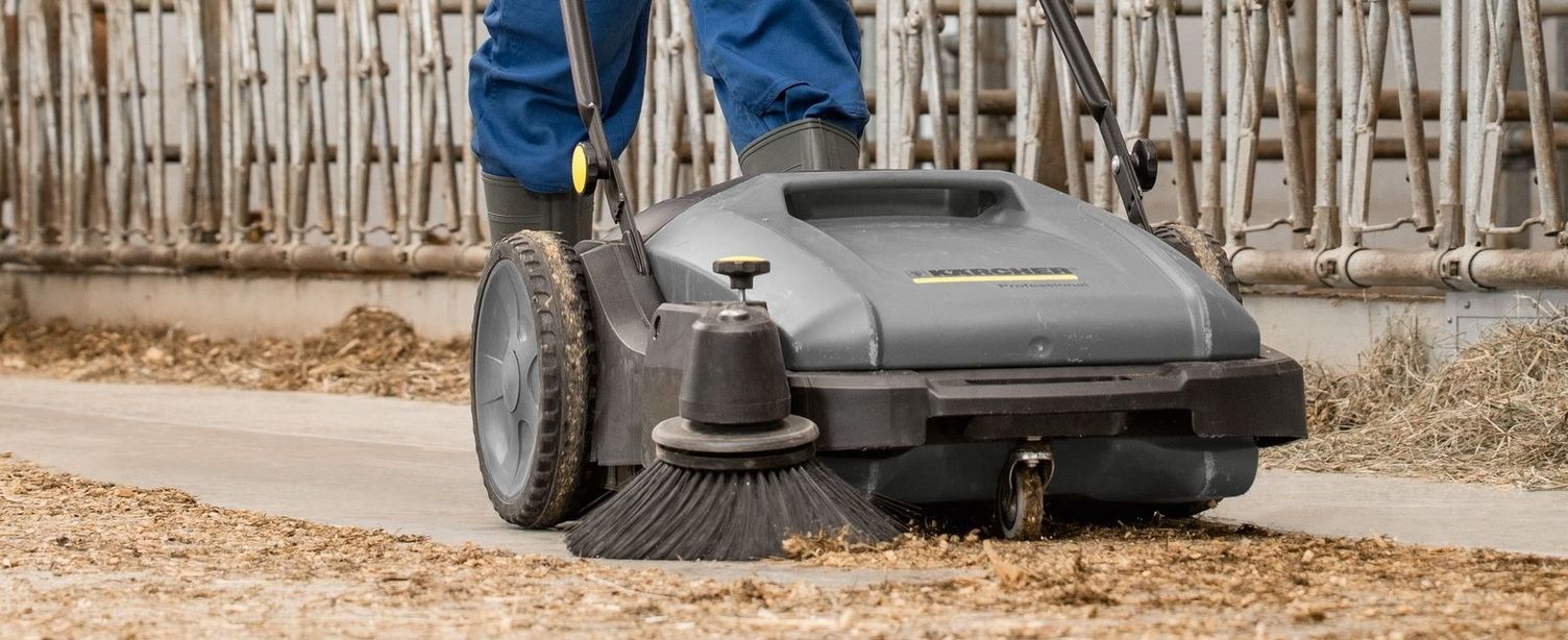 Cleaning the calving pen with a sweeper