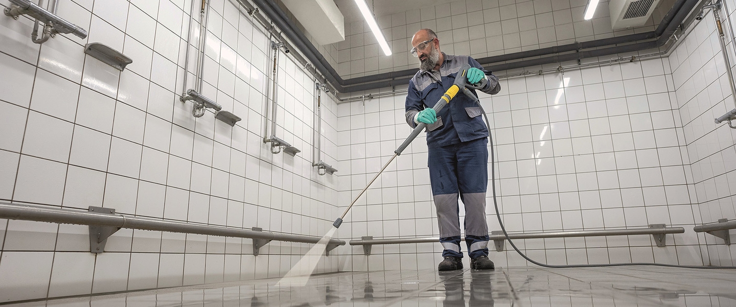 person cleaning showers in Thyssen Krupp production site