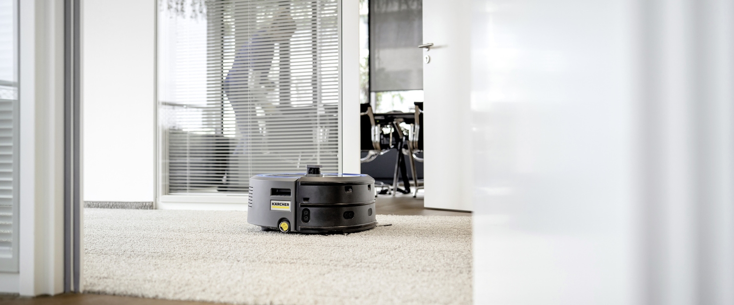 The vacuum robot KIRA cleaning the floor