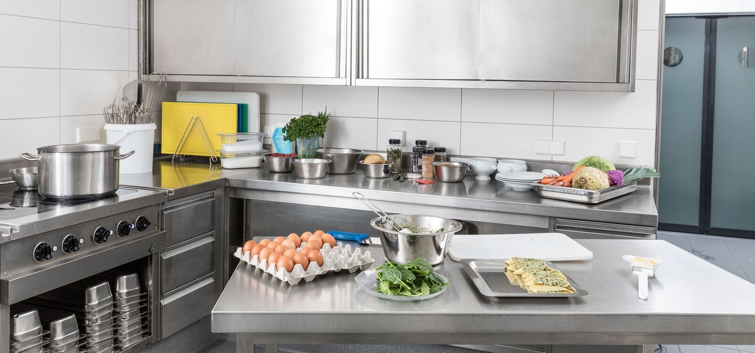 A commercial kitchen with various kitchen utensils and food items