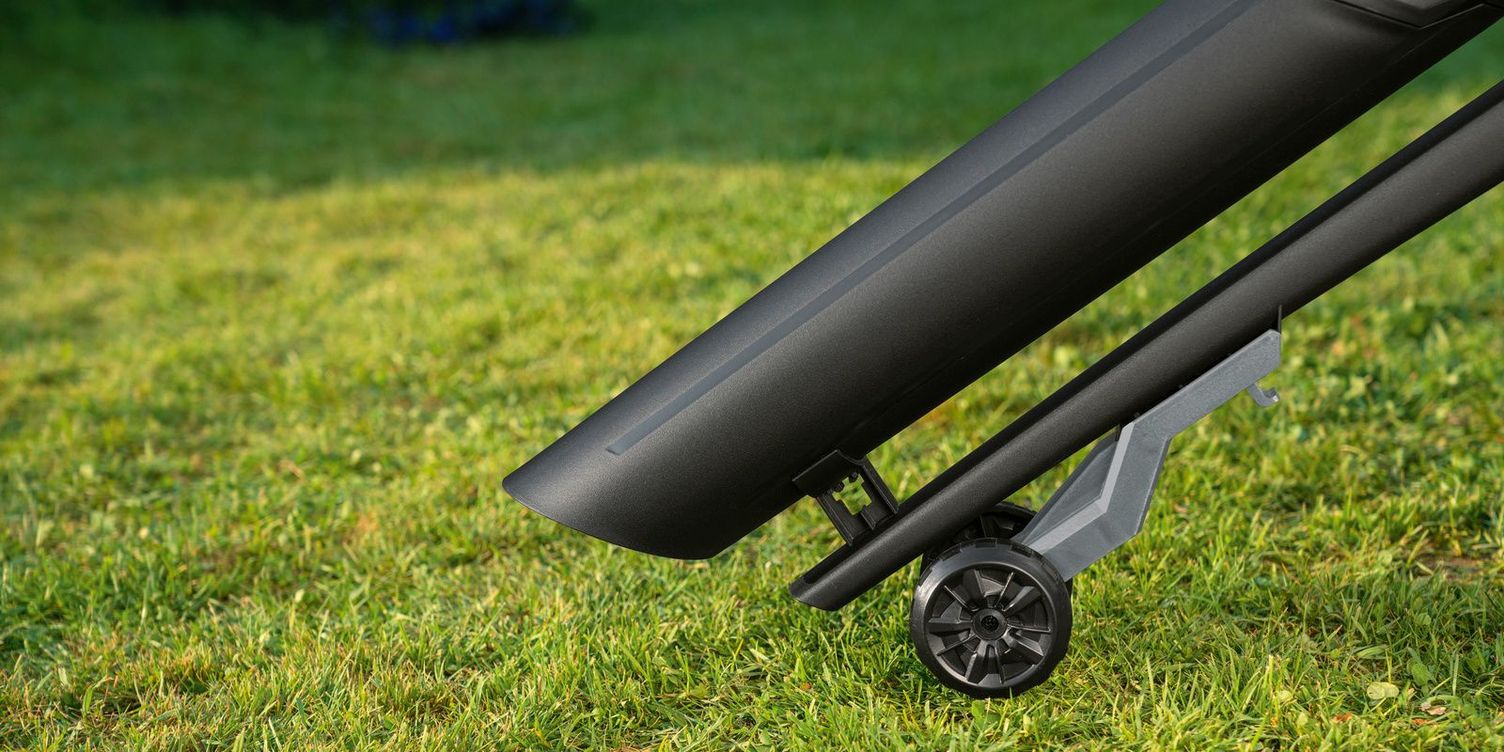 A suction and blowing tube with guide rollers on the lawn