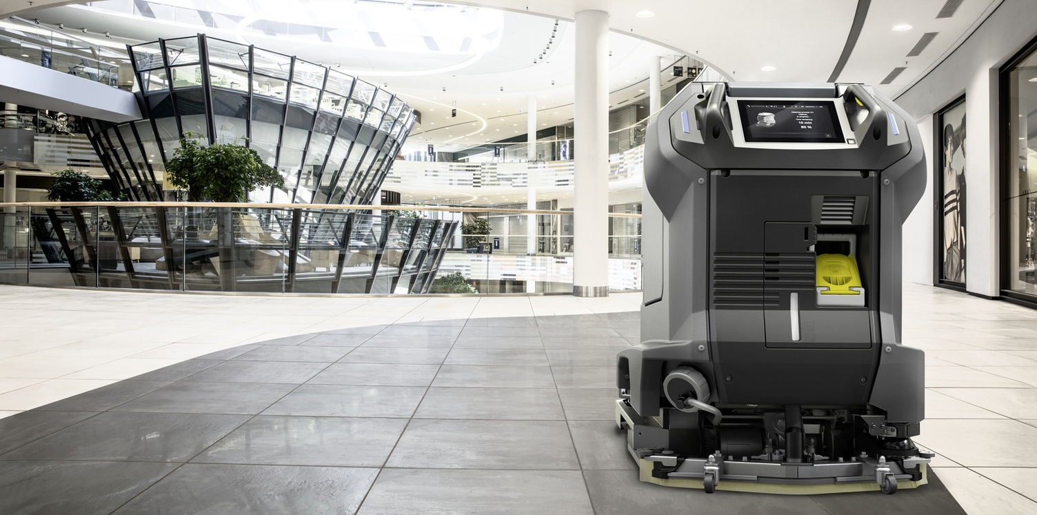 A robot cleans a floor surface