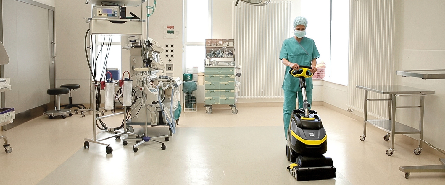 A person cleans the floor of an operating room