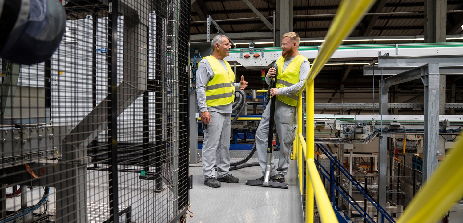 Two people talking to each other at a production site