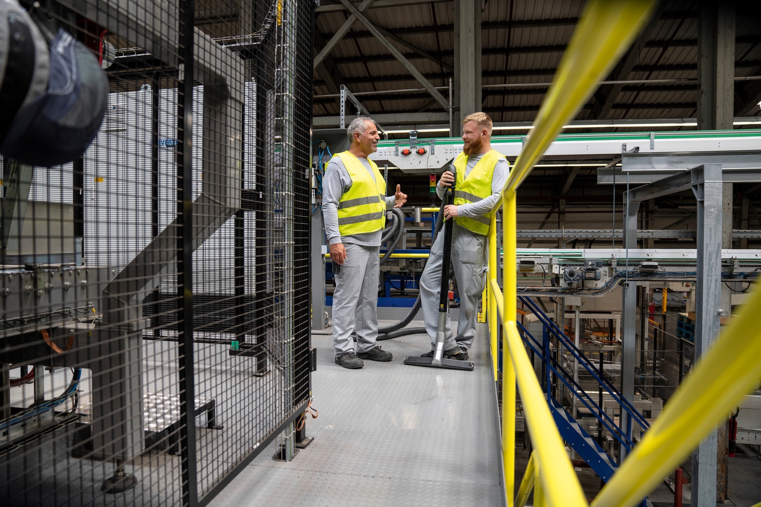 Two employees talking in a production building
