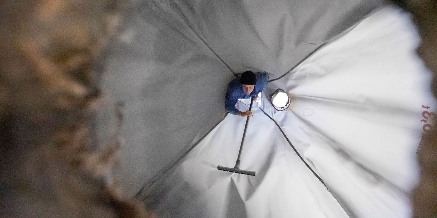 Cleaning Trevira sacks View of an inner silo with Trevira tarpaulins containing some pallets with feed sacks.
