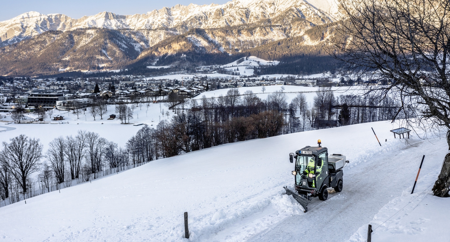 A person clearing a cycle path in winter with a Kärcher clearing device