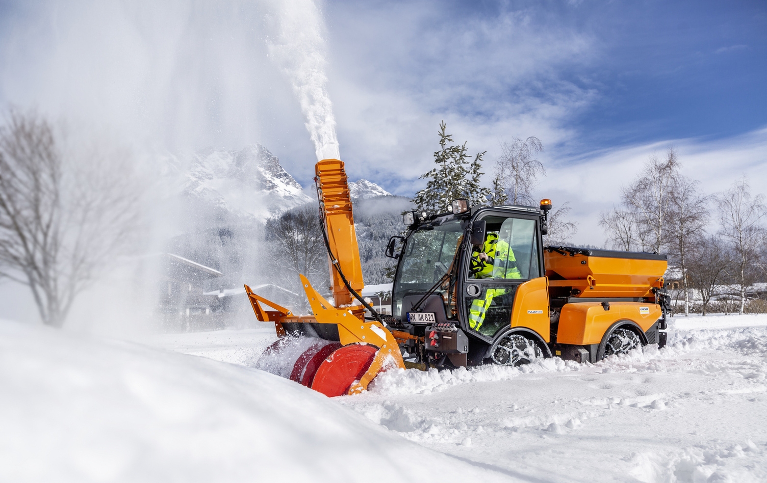 A person operating a Kärcher snow thrower in deep snow