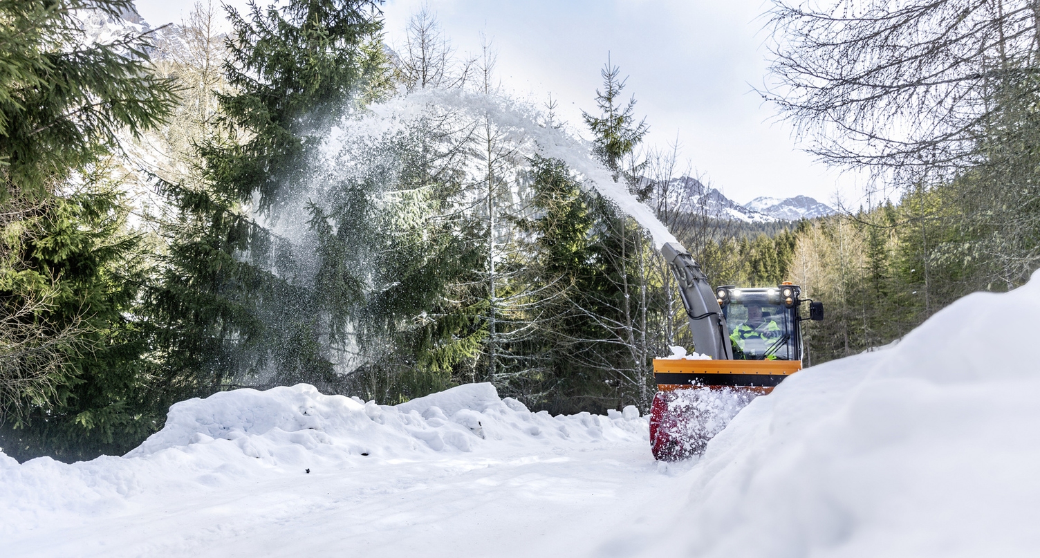 A snow blower clearing snow from a path