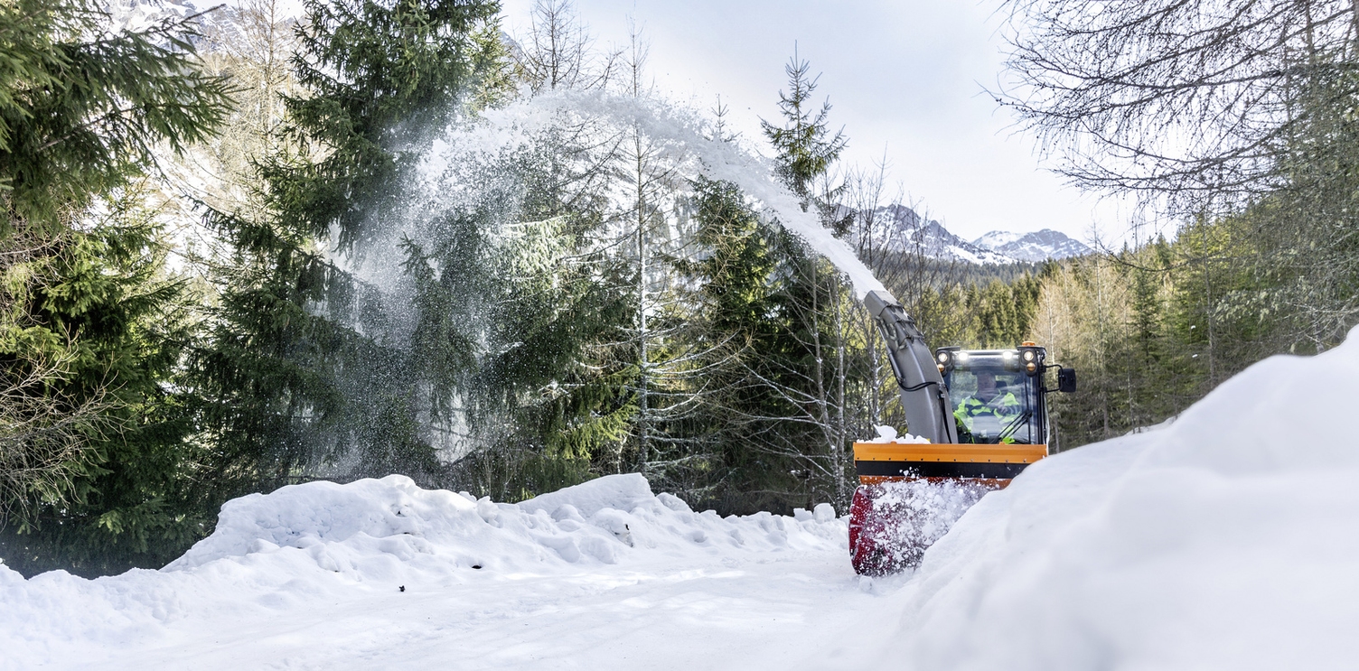 A snow blower clears a path of snow