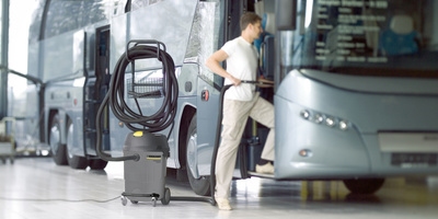 Person cleaning a bus with the battery powered backpack vacuum cleaner Person cleaning a bus with the battery powered backpack vacuum cleaner