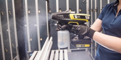 Person spraying a chaning room with disinfectant Person spraying a chaning room with disinfectant