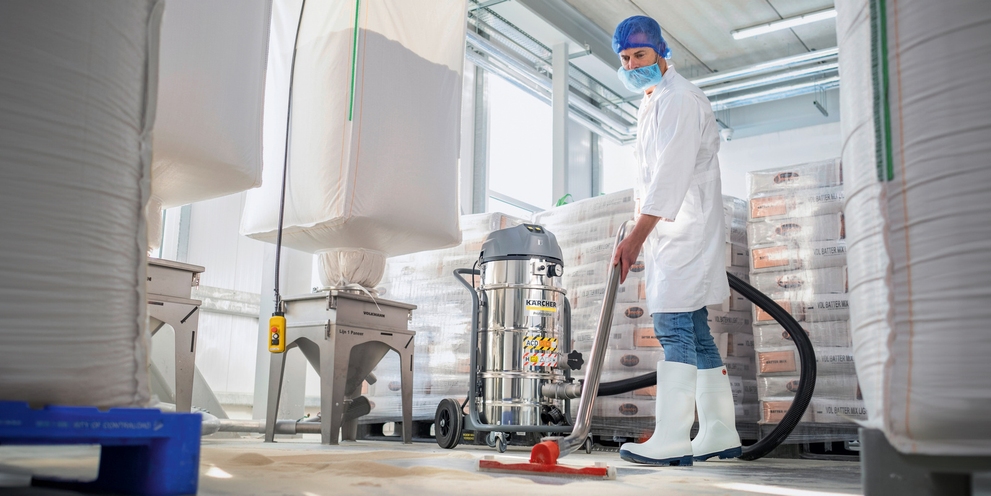 A person cleans the floor with the industrial vacuum cleaner