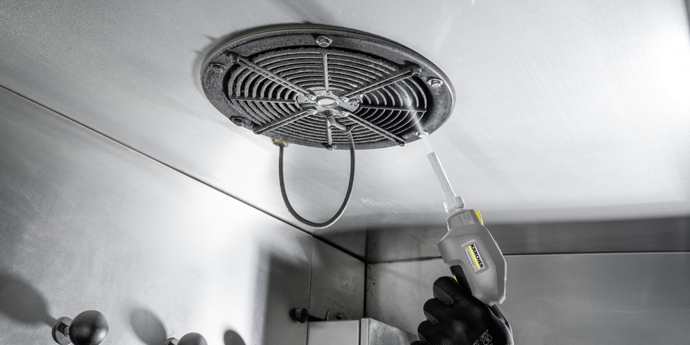 Dry ice is sprayed on contaminants using compressed air