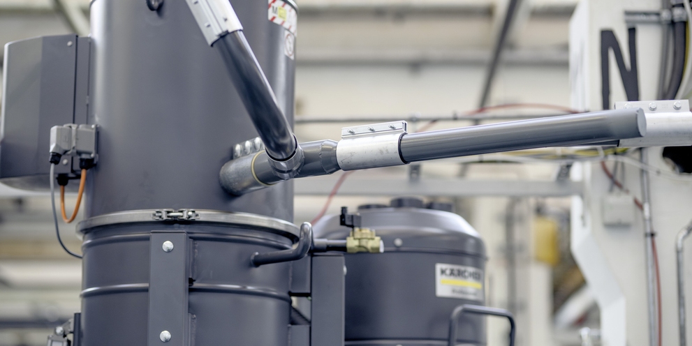  A stationary industrial vacuum system with piping and suction