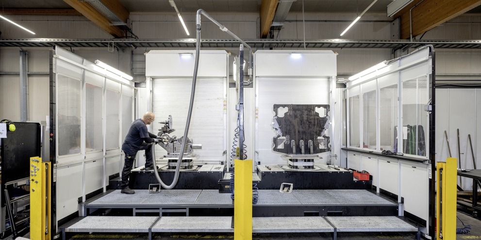 A man operates an extraction system in the automotive industry