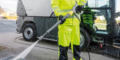 Person cleaning a bus stop with a MC 250 Person cleaning a bus stop with a MC 250