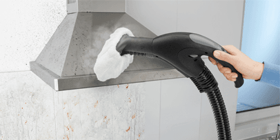 Kärcher SV 7 with hand nozzle and microfibre cloth cleans grease from an exhaust hood.