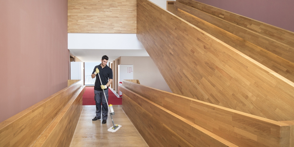 The spray mop system in use A person cleaning the stairwell with the spray mop system