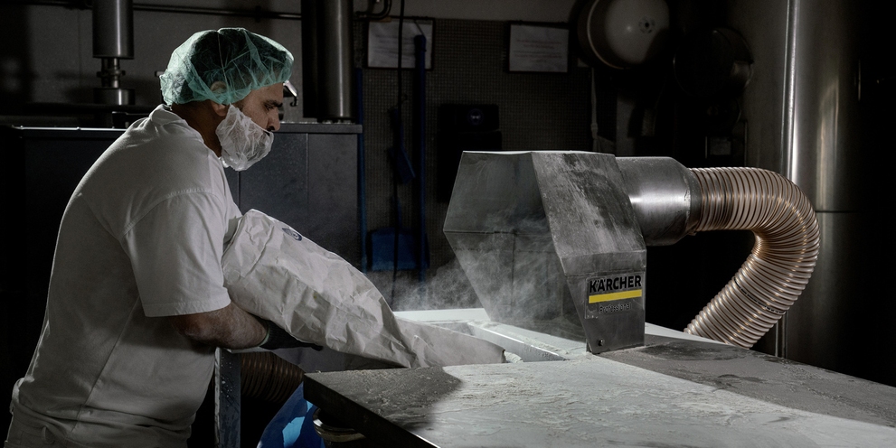 A person in front of an extraction system in the food industry