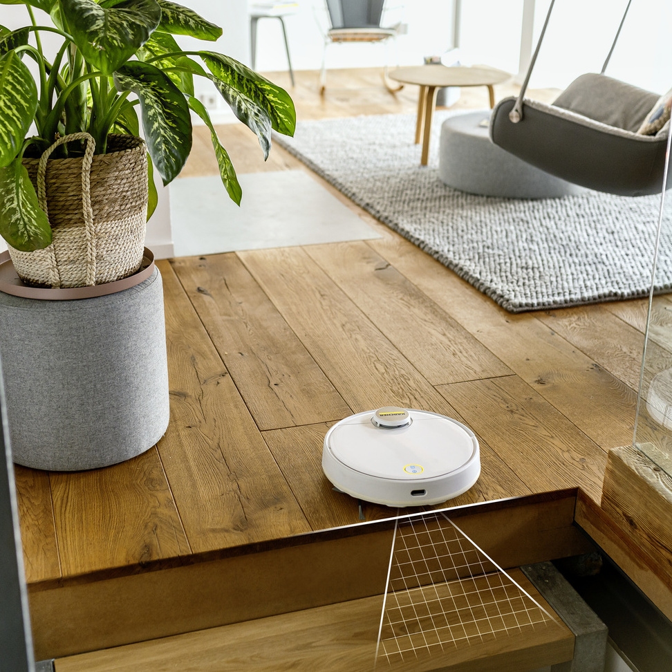 Autonomous cleaning Robot vacuuming and mopping in front of stairs