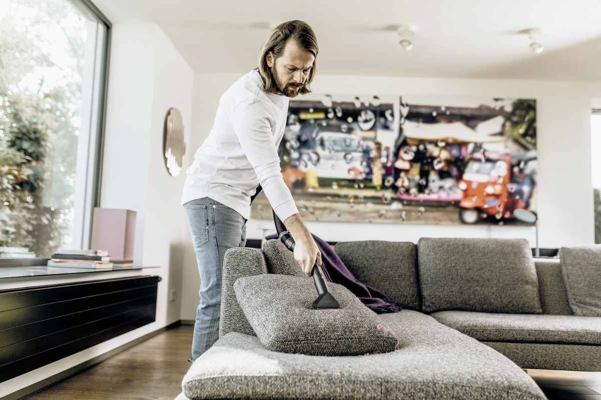 Removing pet hair from the floor with a cordless electric broom Removing pet hair from the floor with a Kärcher cordless electric broom