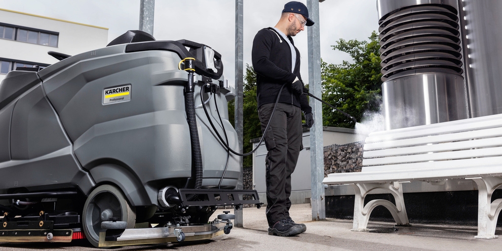Person disinfecting outside area with Kärcher scrubber dryer