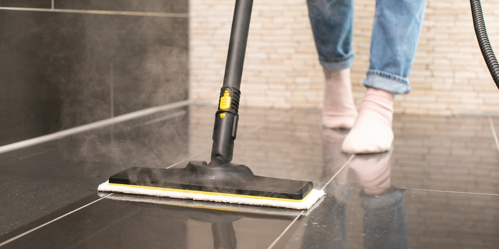 Floor cleaning with steam cleaner Person cleaning floor using Kärcher steam cleaner