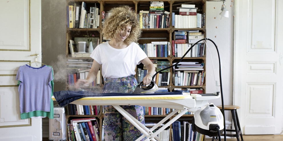Ironing with steam pressure iron Woman ironing with steam cleaner with steam pressure iron