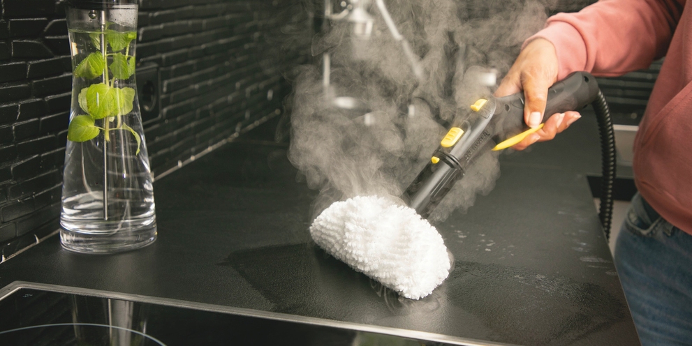 Cloth kits for steam cleaner Person cleaning kitchen with steam cleaner