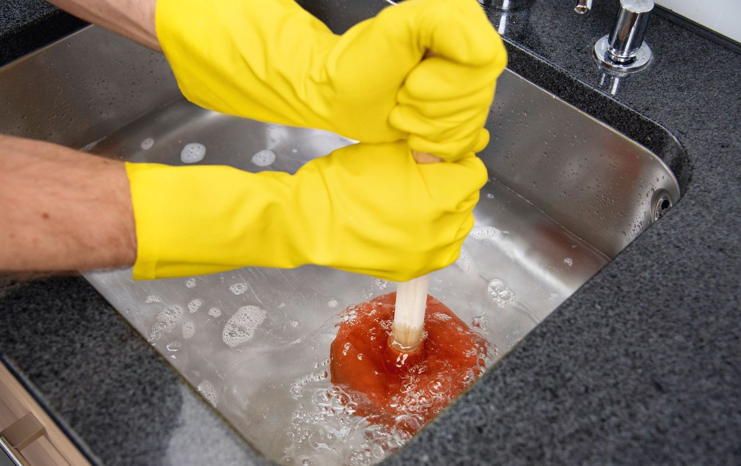 Cleaning drains with a tool