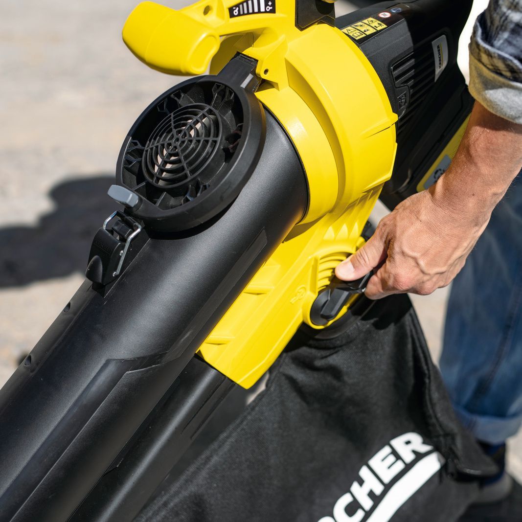 One hand operates the lever on the Kärcher appliance to change the functions