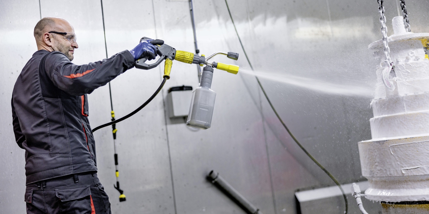 Man sprays component with foam