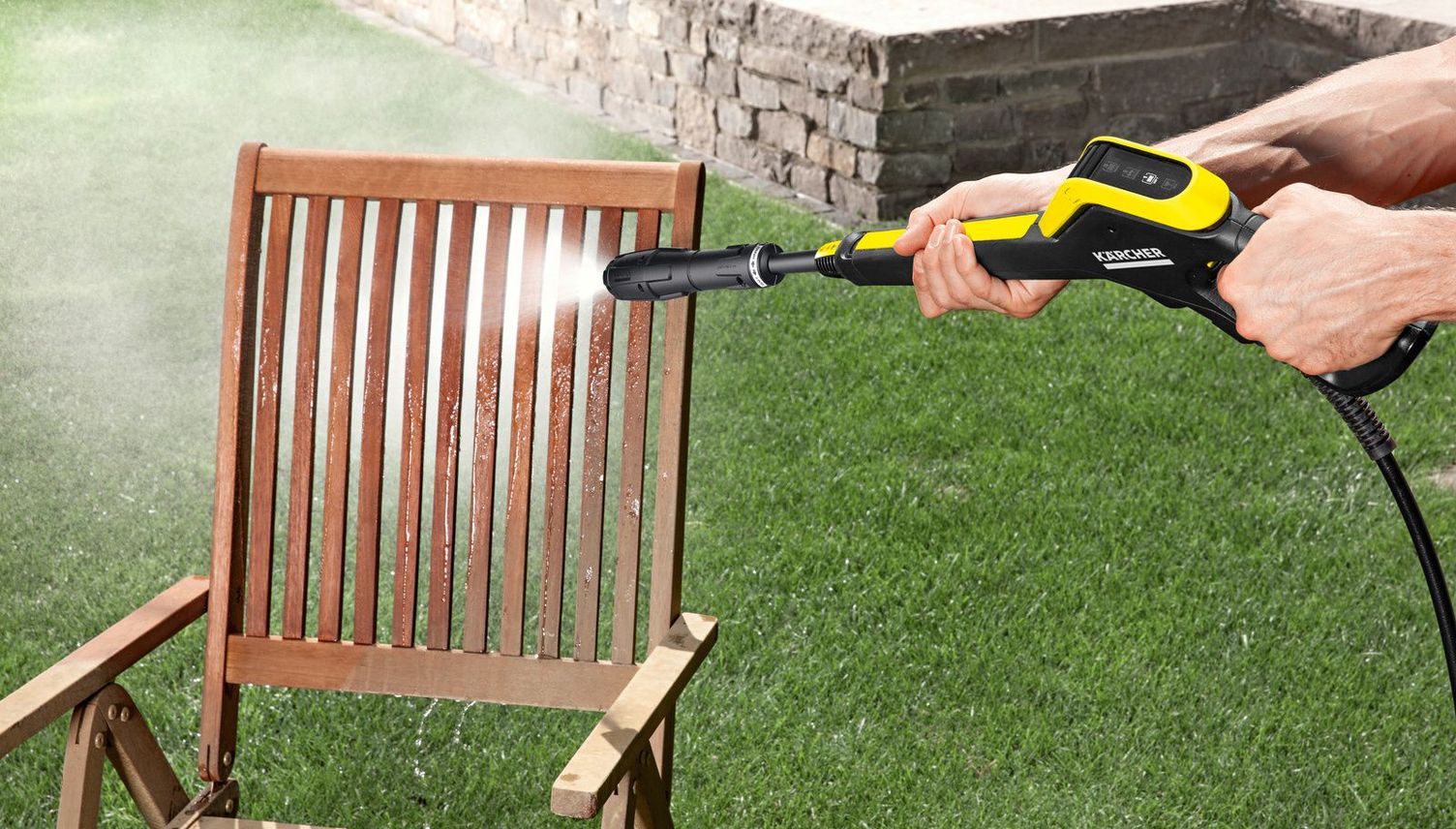 A garden chair is cleaned with a Kärcher medium pressure washer