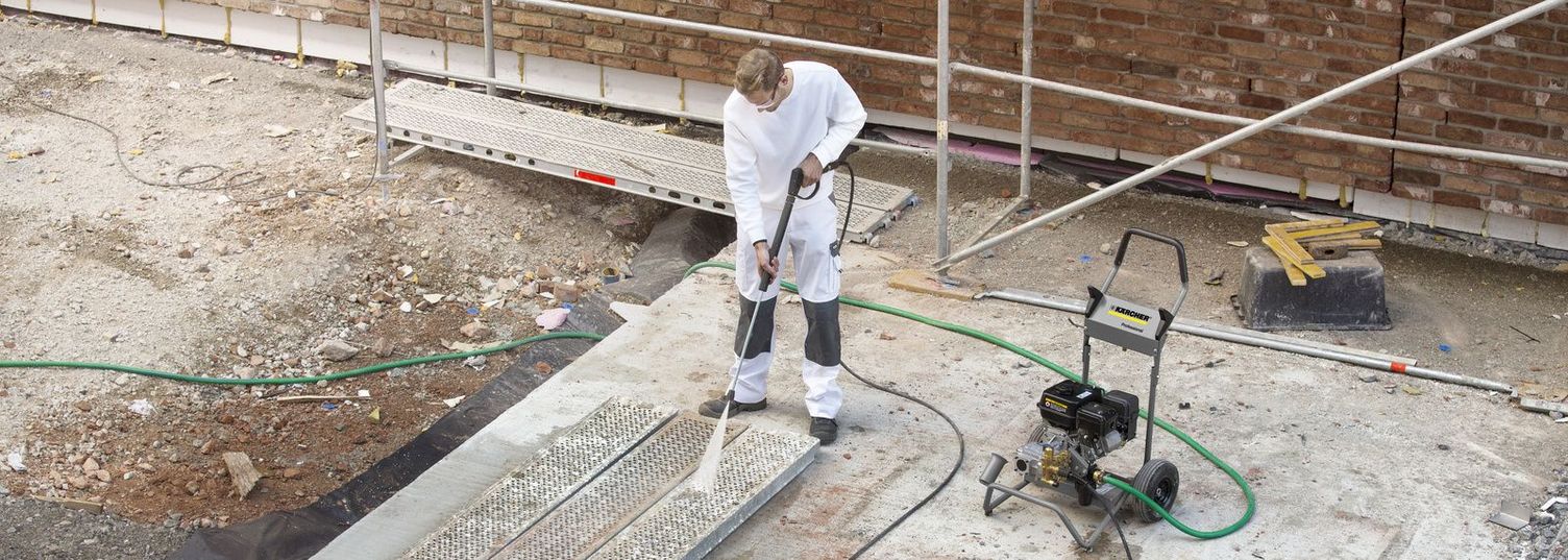 A person is scaffolding cleaning with a Kärcher High-Pressure Cleaner