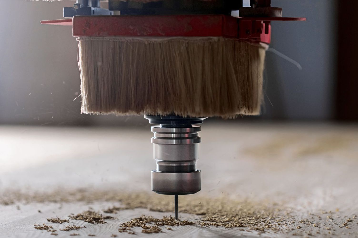 A person drills wood