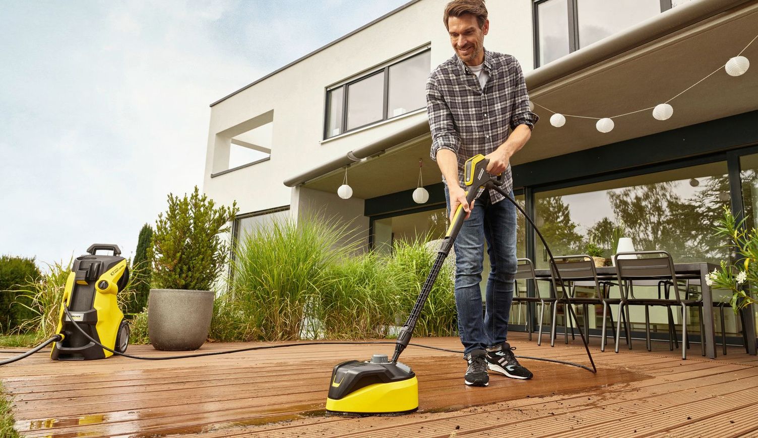 A woman vacuums her wooden deck