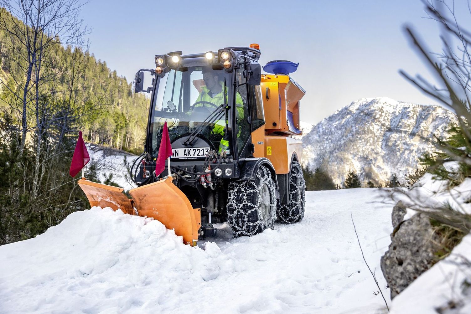 A snow plough clears the snow in a mountainous area