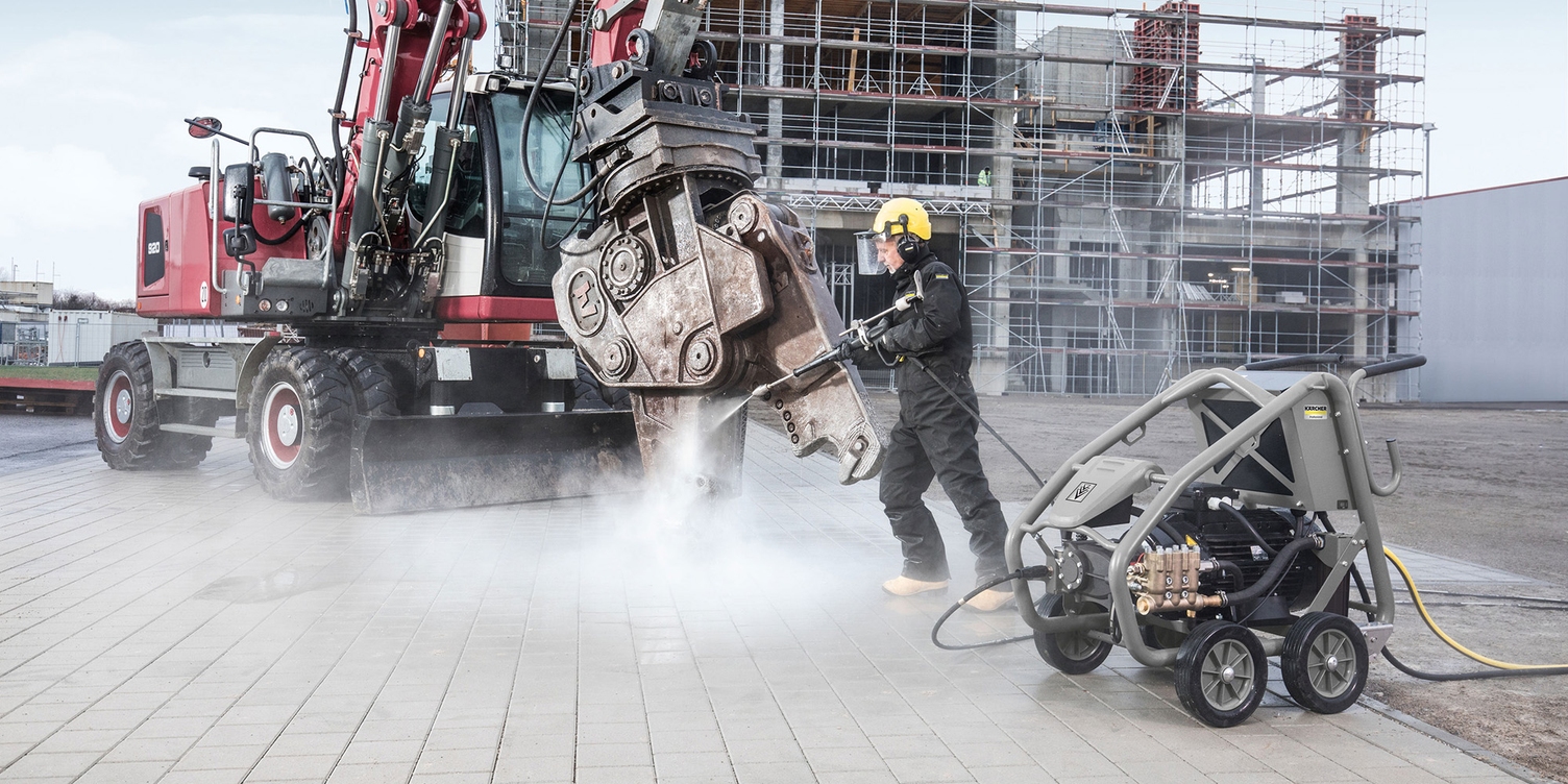 Cleaning construction equipment with a pressure washer