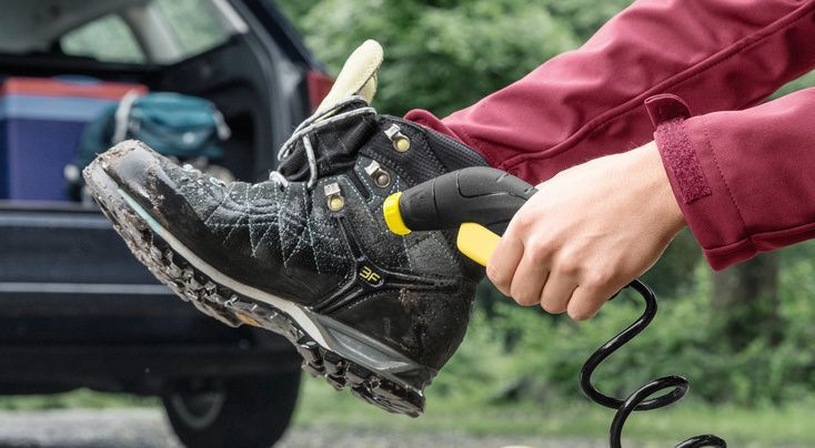 Clean hiking boots A woman cleans her hiking boots with a Kärcher OC 3