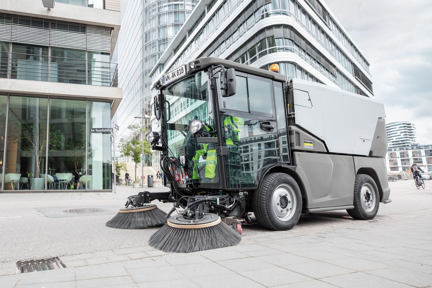 A sweeper surrounded by modern architecture