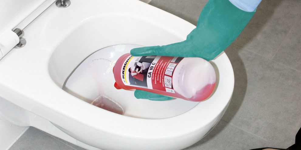 Applying cleaning agents in the bathroom of the hotel room